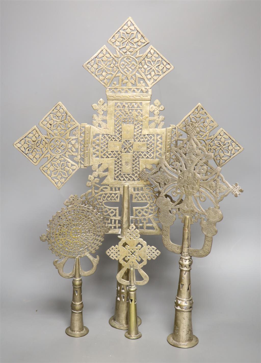 Four Ethiopian Coptic silvered brass processional crosses, H 52cm (largest)